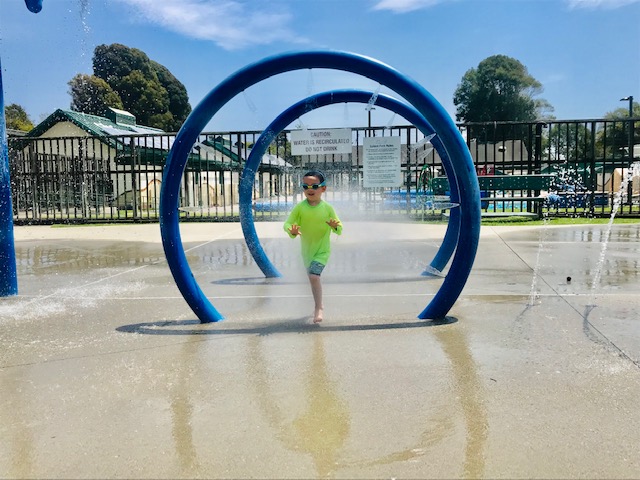 kid running through water