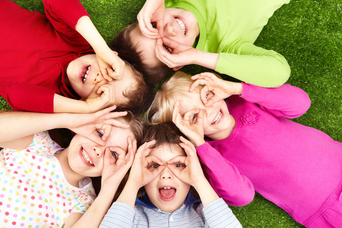 Kids at summer camp playing in a park