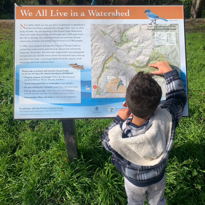 sausal creek sign and child