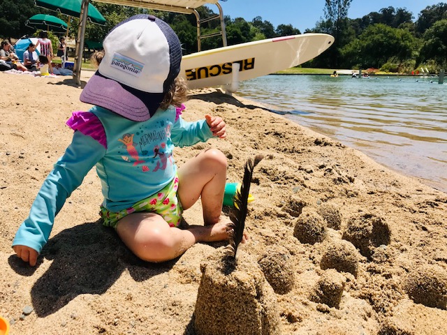 toddler playing at beach