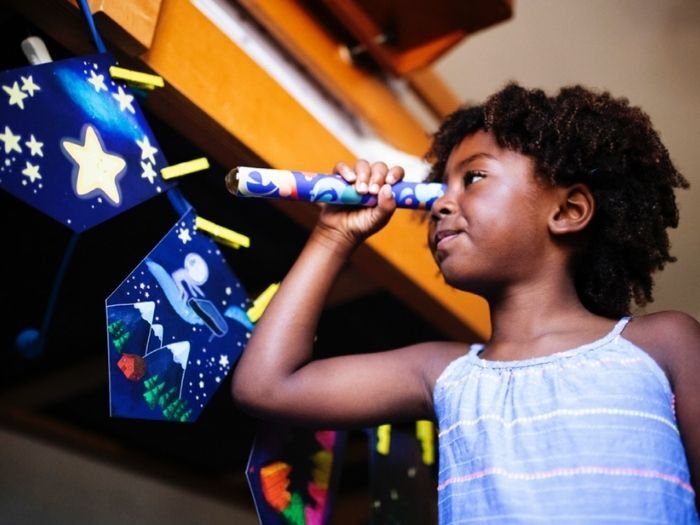 Child looking through telescope at BACT's Play On Live