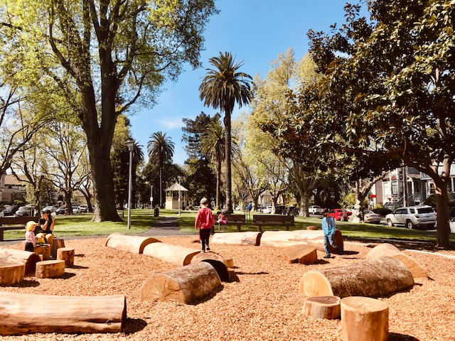 playground with child balancing on logs