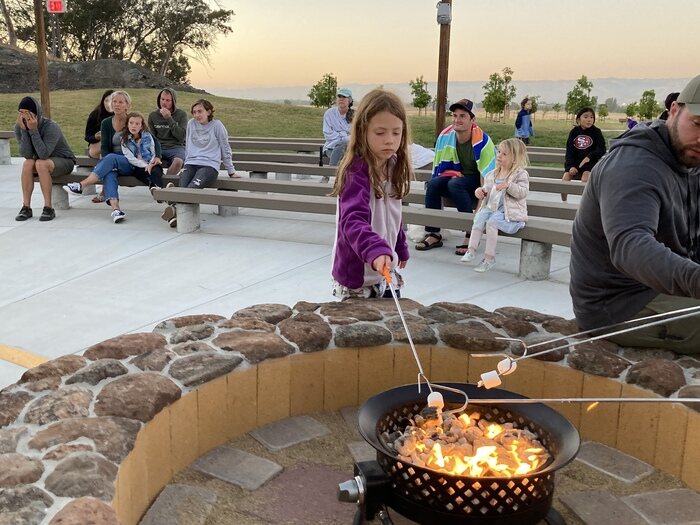 child roasting marshmallow for smore