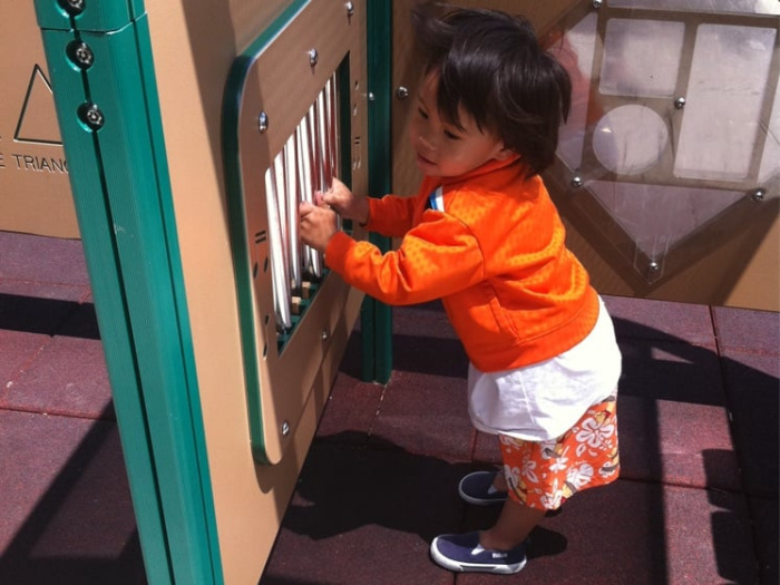 toddler on a play structure zoom in close up