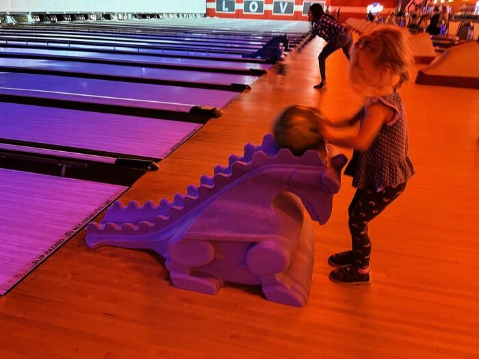 Child using ramp to bowl