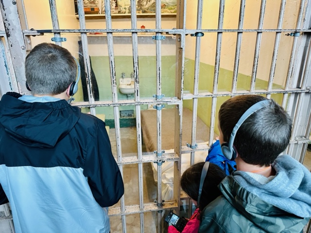 kids looking in prison cell