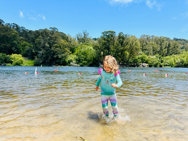 toddler running in shallow lake water