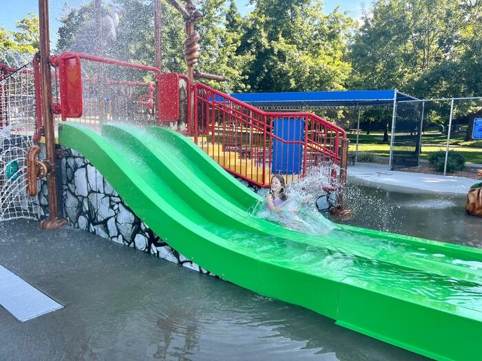 Child splashes down water slide