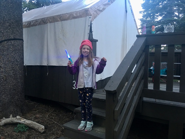 Child outside canvas tent at Echo Lake Family Camp